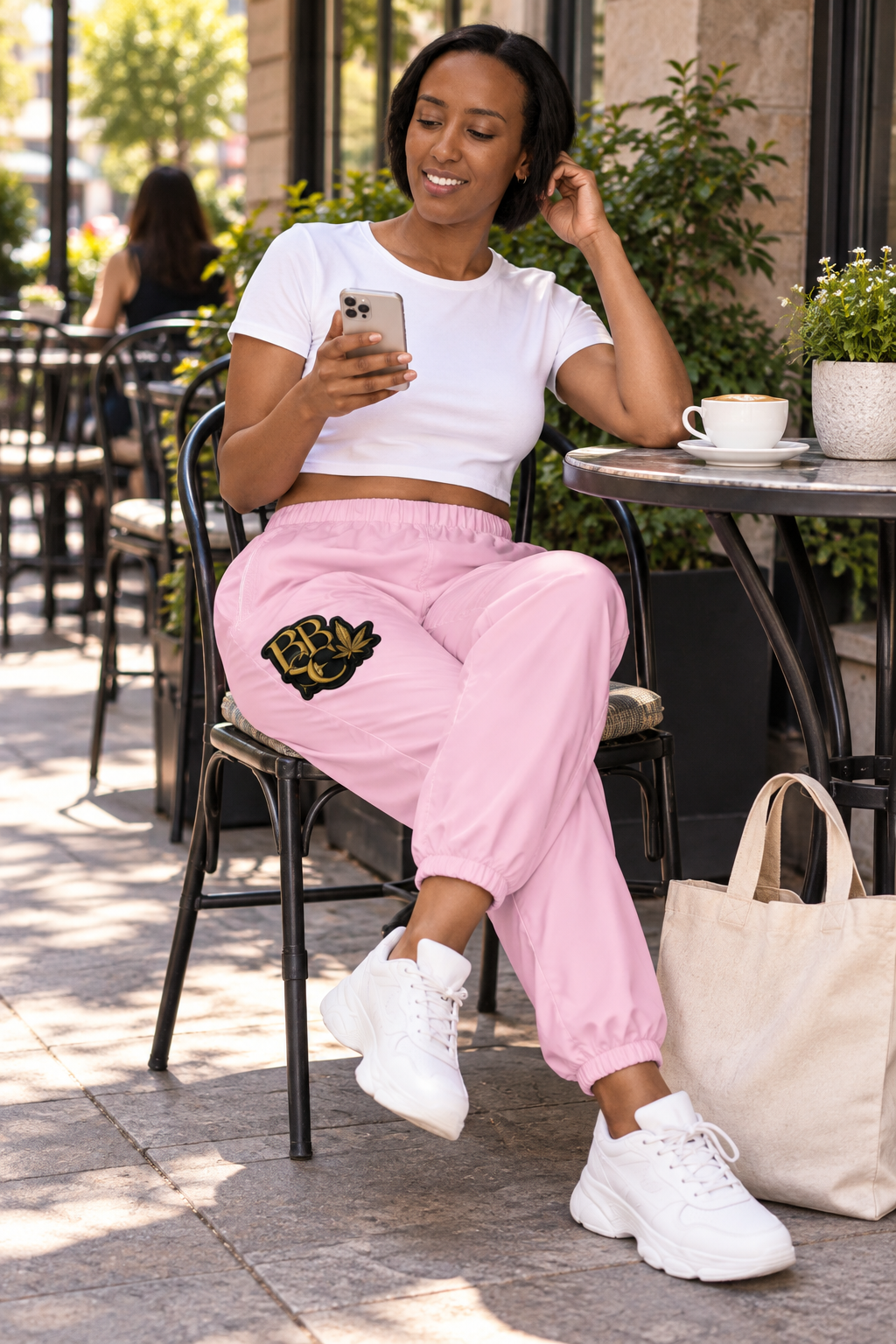 BBSC Peek-a-Boo Leaf Pink Track Pants cafe lifestyle mockup